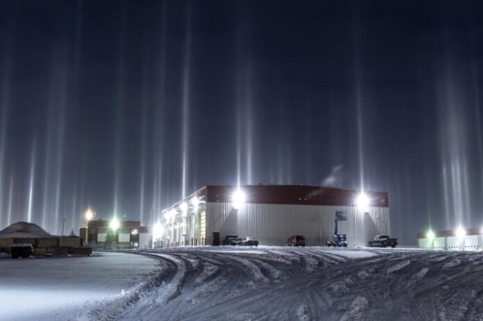 Des piliers de lumière illuminent le ciel glacial d'Alberta